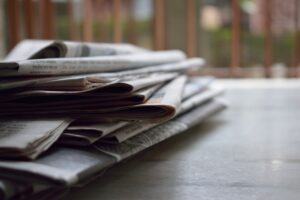 Stock image of a stack of newspapers. This is to illustrate the changing style guide journalists follow for the article Emerging from the Dark Ages into the Light and Right: Decolonize your writing and become LGBTQ2S+ friendly